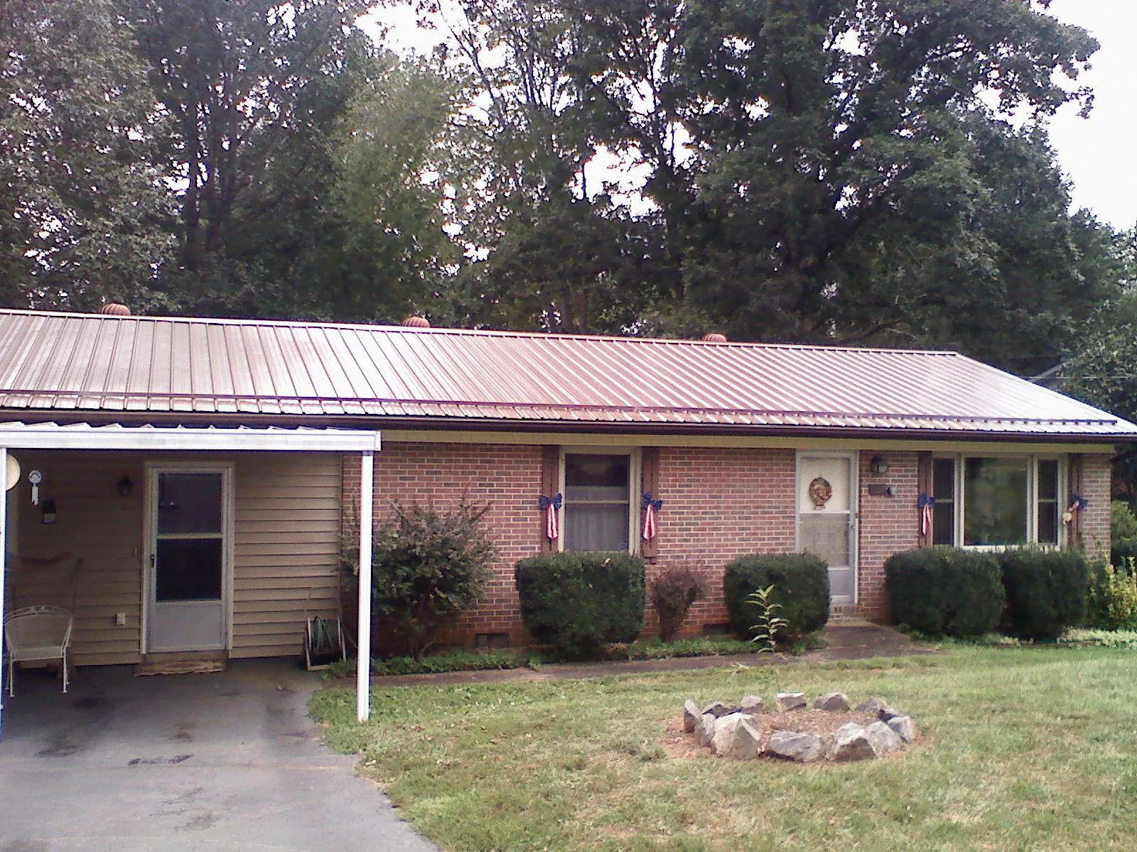 Bronze metal roof and carport on a brick ranch home — Roof Repair work by our crew in Stony Point