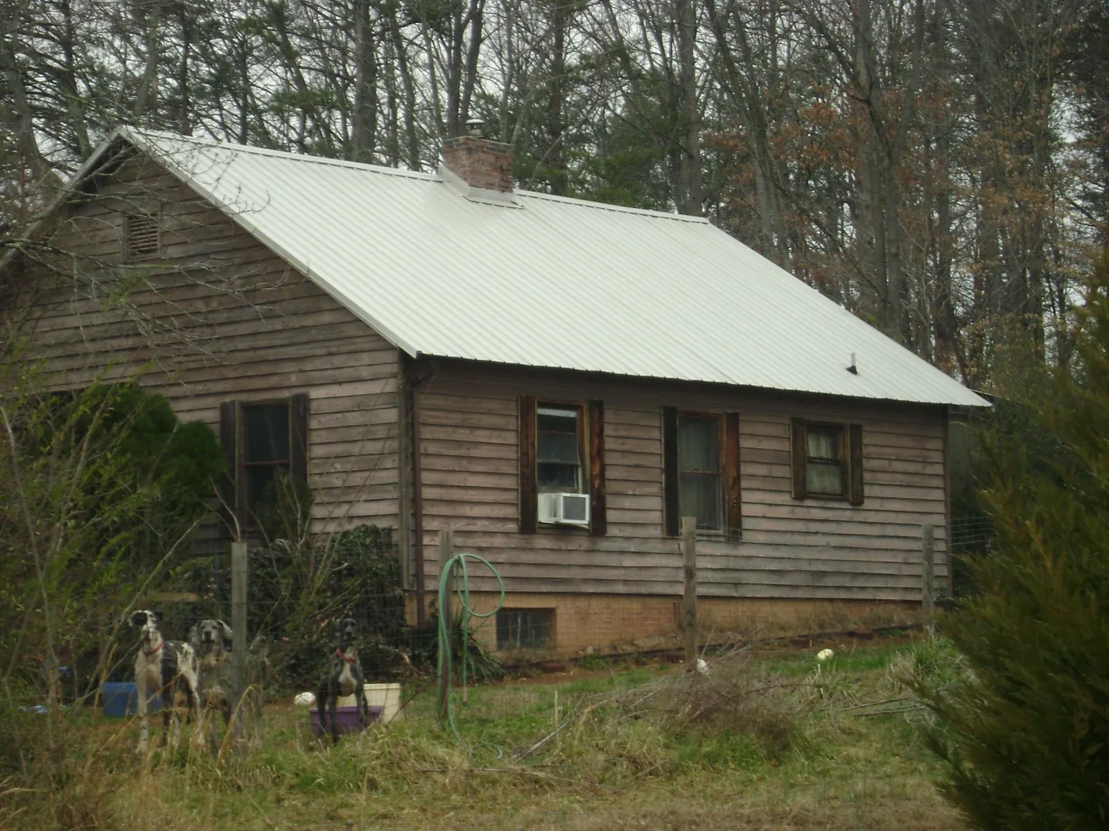 White metal roof on an old wood sided farmhouse, from a Metal Roof Installation job in Stony Point